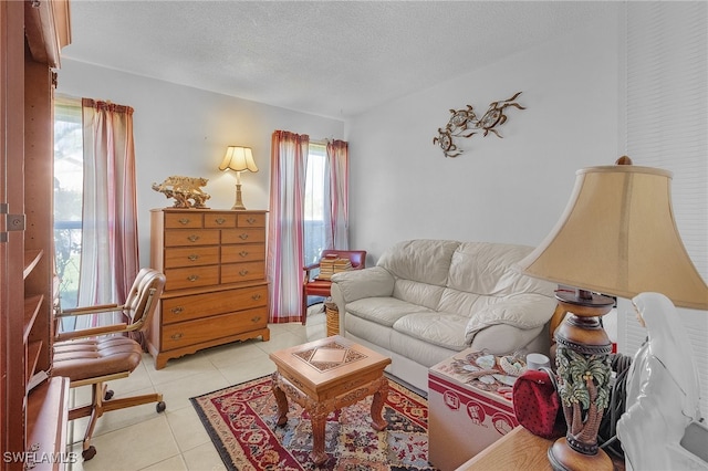 living room featuring a textured ceiling, a healthy amount of sunlight, and light tile patterned floors