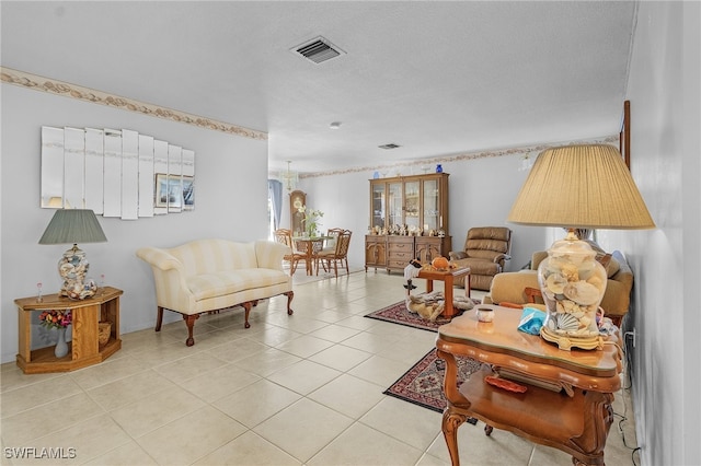 living room with a textured ceiling and light tile patterned floors