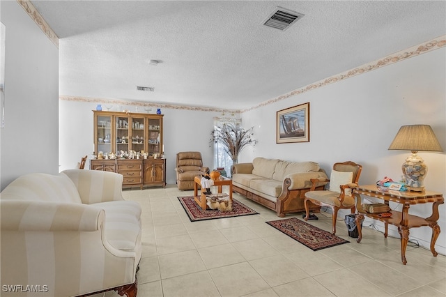 living room featuring a textured ceiling and light tile patterned floors