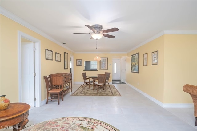 tiled dining area with ornamental molding and ceiling fan