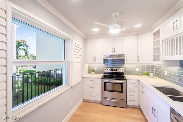 kitchen with a healthy amount of sunlight, stainless steel appliances, white cabinetry, and sink