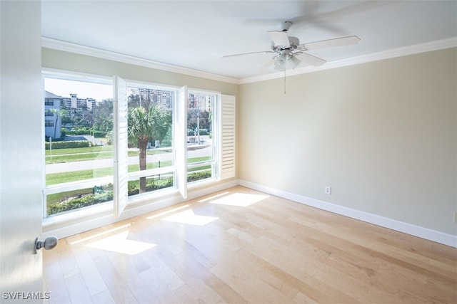 empty room featuring light hardwood / wood-style floors, crown molding, and ceiling fan