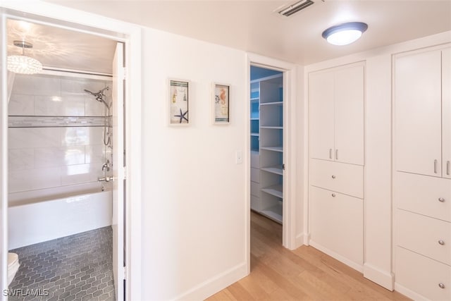 corridor with light hardwood / wood-style floors