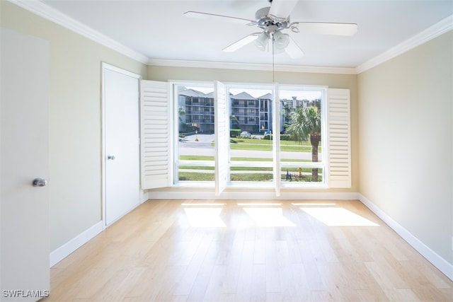 spare room featuring light hardwood / wood-style floors, ornamental molding, and ceiling fan