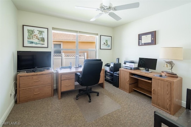 carpeted home office featuring ceiling fan