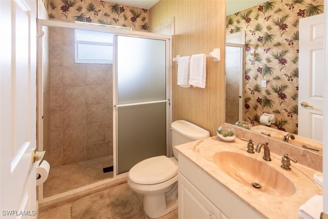 bathroom featuring an enclosed shower, vanity, and toilet