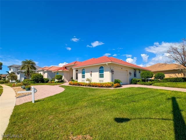 mediterranean / spanish-style house with a garage and a front lawn