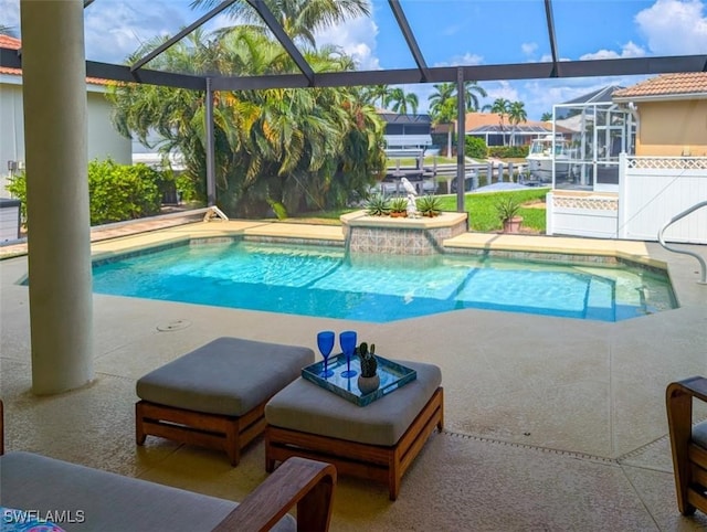 view of swimming pool with glass enclosure and a patio area