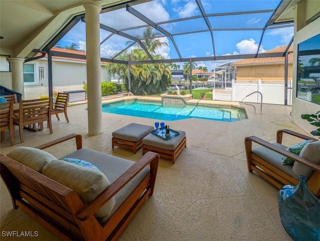 view of swimming pool with a lanai, a patio, and a hot tub