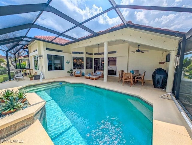 view of swimming pool featuring a patio area, ceiling fan, and a lanai