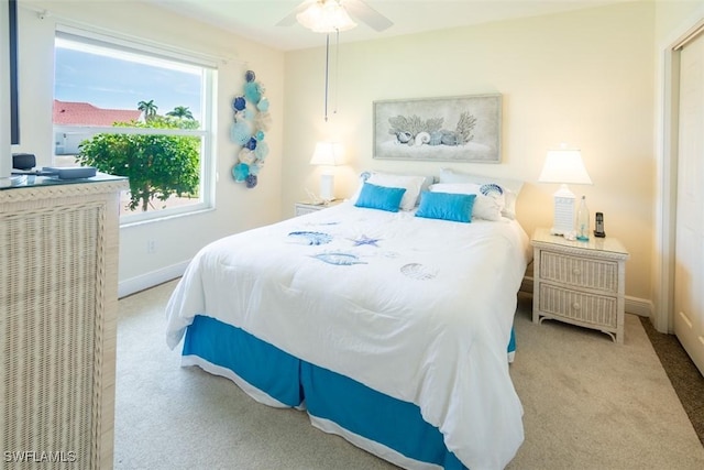 bedroom with ceiling fan and light carpet