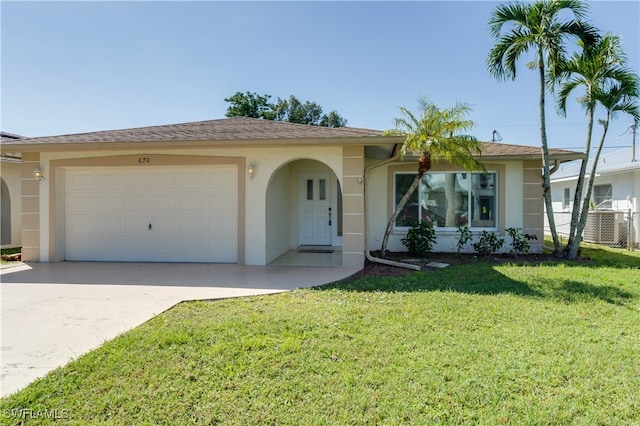 single story home with a garage and a front lawn