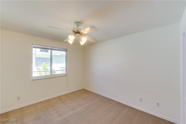 unfurnished room featuring light colored carpet and ceiling fan