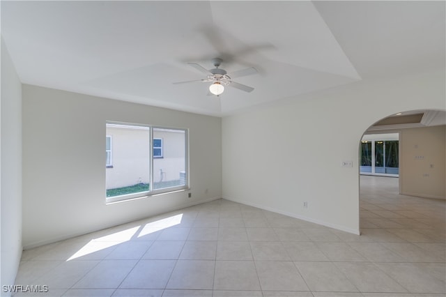 tiled empty room with ceiling fan