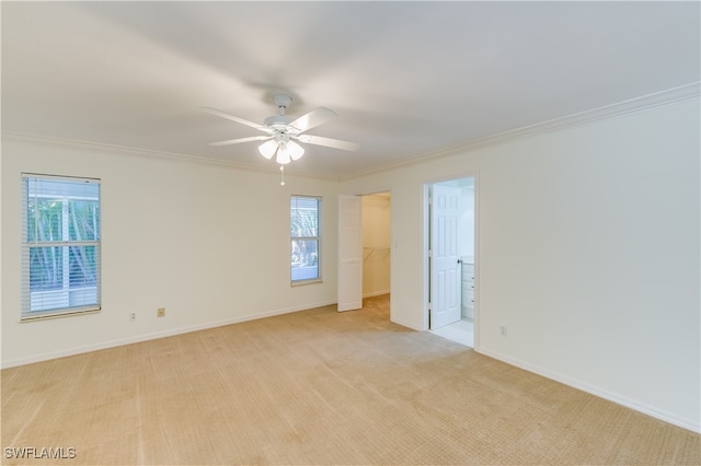 carpeted empty room with ceiling fan and ornamental molding