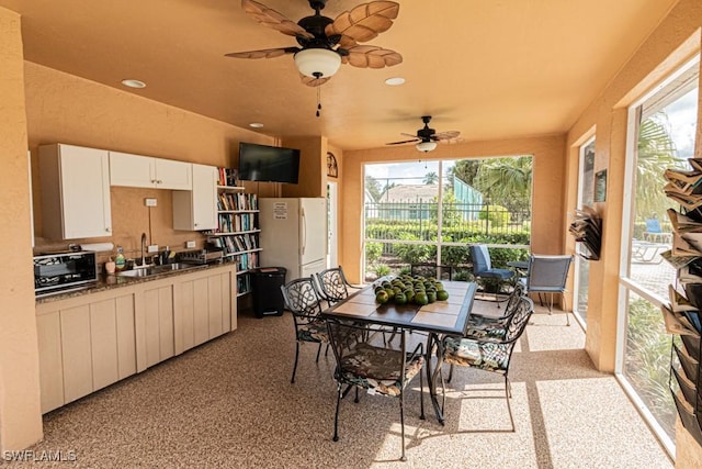 exterior space with ceiling fan and sink