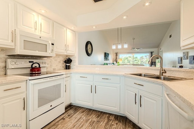 kitchen featuring decorative light fixtures, sink, white cabinets, and white appliances