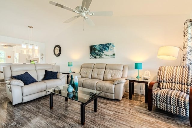 living room with lofted ceiling, ceiling fan, and hardwood / wood-style floors