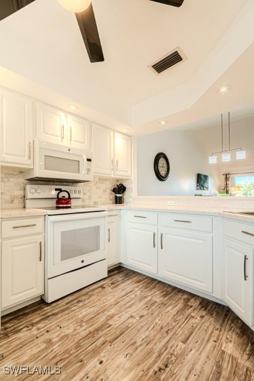 kitchen featuring white cabinetry, light hardwood / wood-style floors, white appliances, and tasteful backsplash