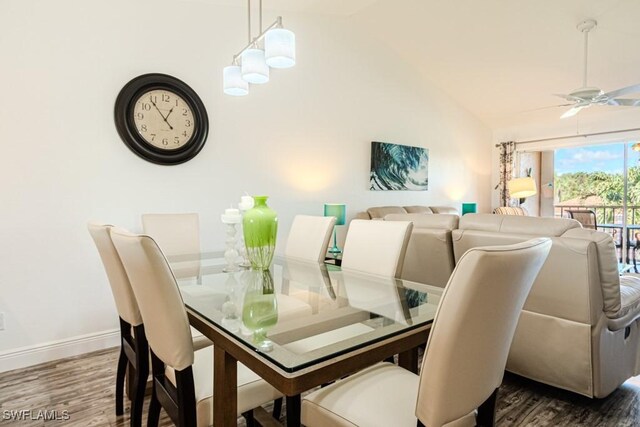 dining room with ceiling fan, hardwood / wood-style floors, and lofted ceiling