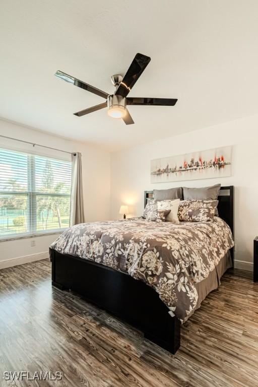 bedroom featuring ceiling fan and dark hardwood / wood-style floors