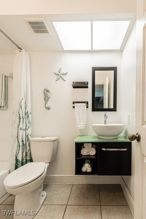 full bathroom with toilet, tile patterned floors, vanity, and shower / bath combo with shower curtain