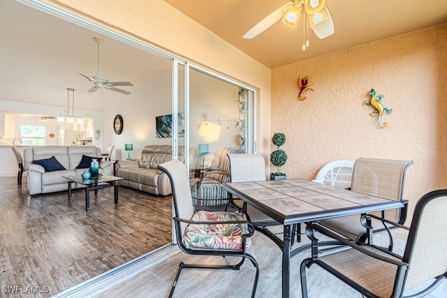 sunroom with ceiling fan and lofted ceiling