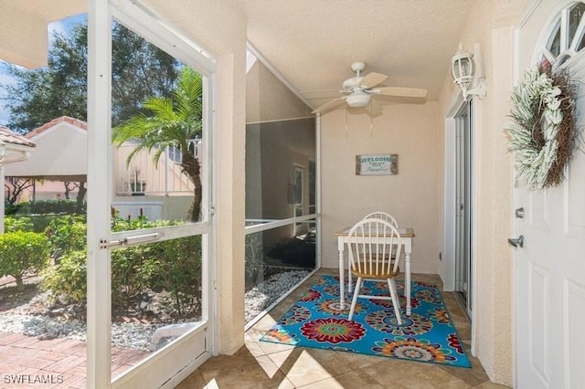 sunroom featuring ceiling fan