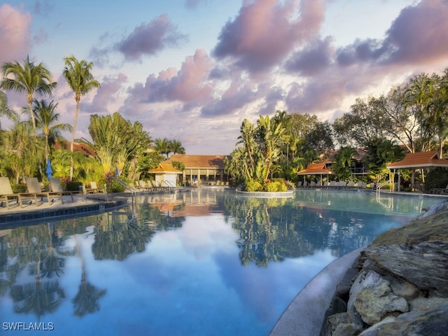 view of pool at dusk