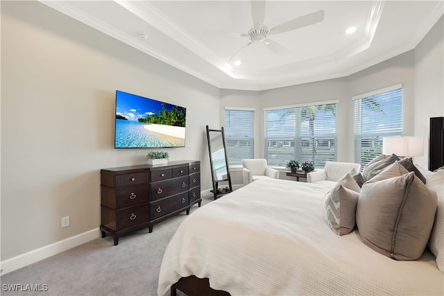 bedroom featuring light carpet, crown molding, a raised ceiling, and ceiling fan