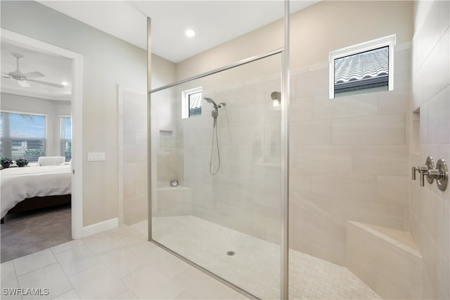 bathroom with tile patterned floors, ceiling fan, and walk in shower