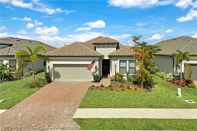 mediterranean / spanish house featuring a garage and a front lawn