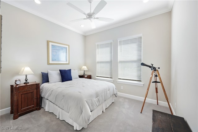 carpeted bedroom with ceiling fan and crown molding