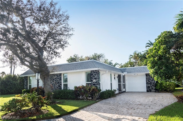 single story home with a front yard and a garage