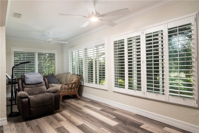 interior space featuring crown molding, hardwood / wood-style flooring, and ceiling fan