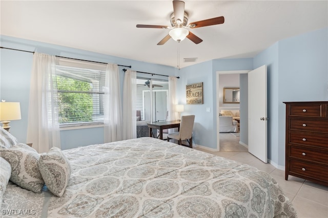 tiled bedroom featuring ceiling fan