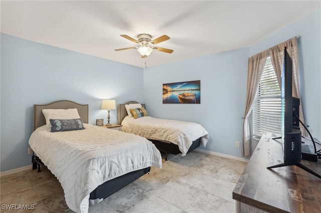 bedroom featuring baseboards and a ceiling fan