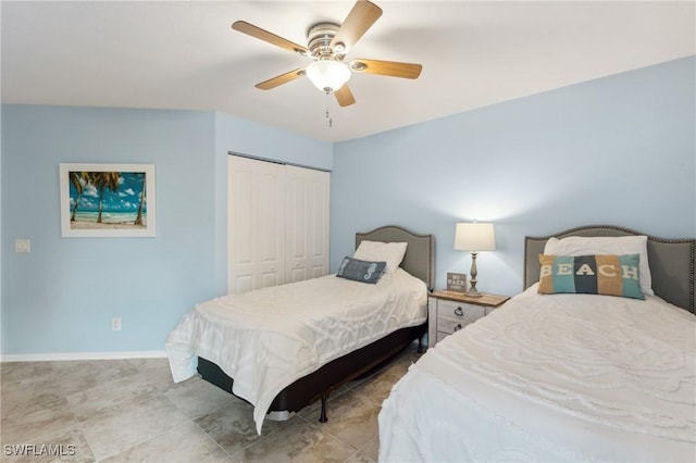 bedroom featuring a closet, baseboards, and a ceiling fan