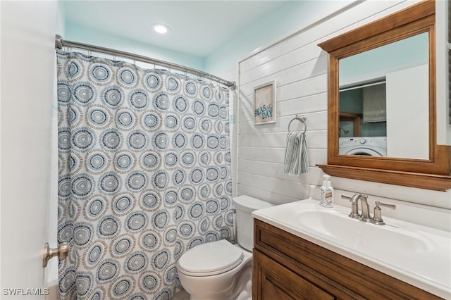 full bath featuring vanity, a shower with shower curtain, wooden walls, washer / dryer, and toilet