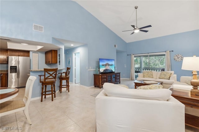 living room featuring light tile patterned floors, visible vents, high vaulted ceiling, and ceiling fan