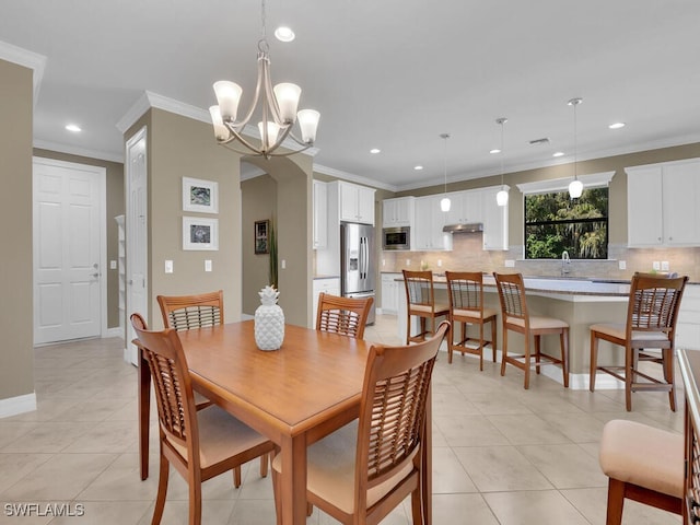 tiled dining area with crown molding and a chandelier