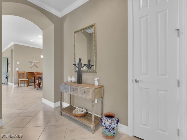 hallway featuring crown molding and light tile patterned floors