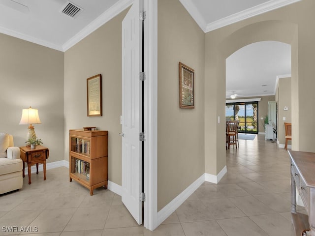 hallway featuring crown molding and light tile patterned floors