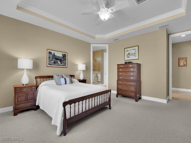 carpeted bedroom with ornamental molding, ceiling fan, and a raised ceiling