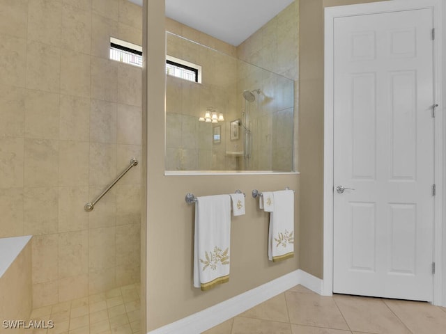 bathroom with tile patterned floors and tiled shower