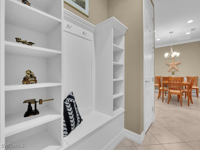 spacious closet featuring light tile patterned flooring and a chandelier