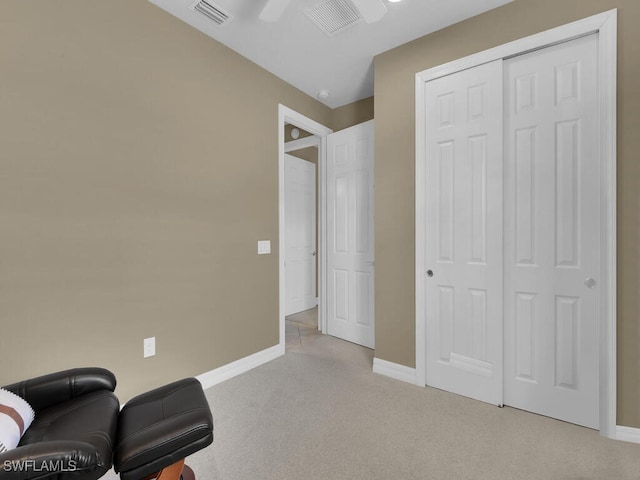 sitting room featuring light colored carpet