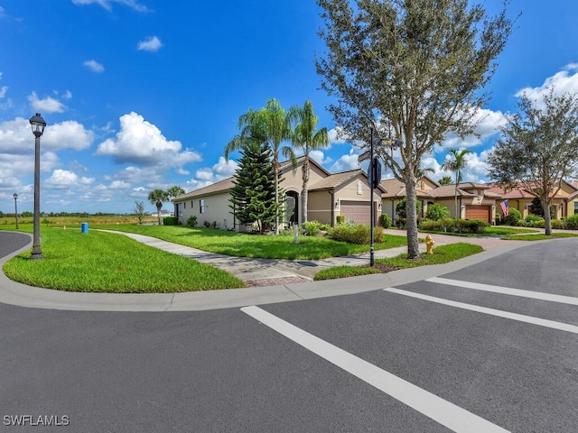 view of front of home featuring a front yard and a garage