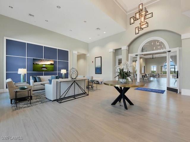 interior space with a towering ceiling and light wood-type flooring