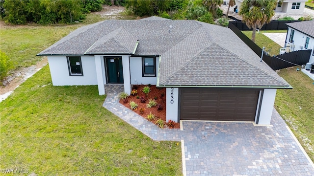 view of front facade with a front yard and a garage